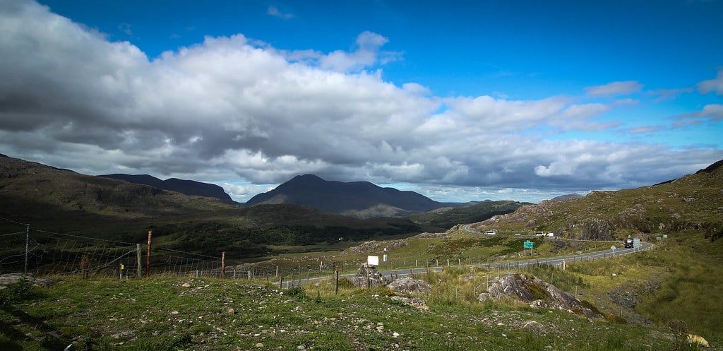 A winding road passes through the rugged mountains and green valleys at Moll's Gap on the Ring of Kerry.