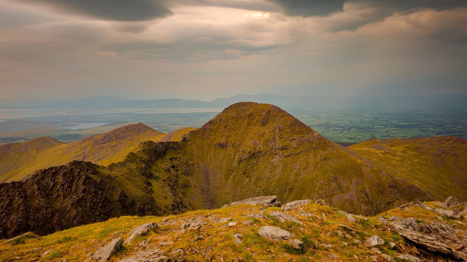 Rugged ridges and the peak of Carrauntoohil rise across the MacGillycuddy's Reeks near the Ring of Kerry.